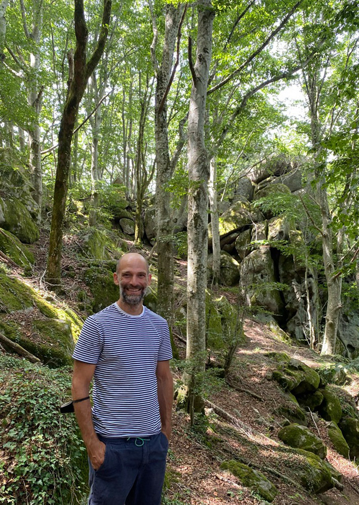 Adam Sello happy in the forest